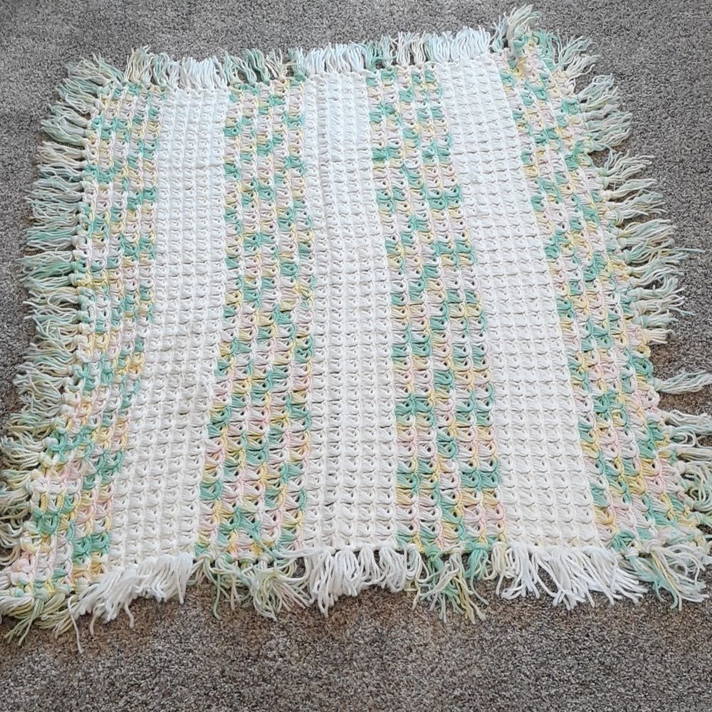Beautiful afgan - green, yellow, pink, and white with long fringe along outside
